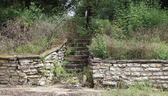 SHARON DONAT | Staff THE WALL NEAR the stairs leading to the Shotwell Cemetery will cost $40,000 to repair, according to Megan Pendleton.