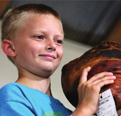 J.C. VENTIMIGLIA | Staff A LONG-TIME participant in Ray County Fair events, Cash Honeycutt, hoists his entry at the ham auction.