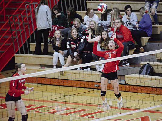 WITH FELLOW SPARTAN Kelly Jaggars, left, and some spectators watching, Richmond first-year high schooler Genevieve Didier leaps to make a touch pass Oct. 20 during Richmond’s season-ending road loss to Oak Grove in Class 3 District 15 Tournament play. SHAWN RONEY | Staff