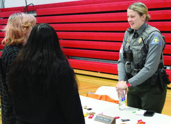 MISSOURI CONSERVATION DEPARTMENT Officer Claire Burch explains her role to students at the Richmond High School job fair. SHARON DONAT | Staff