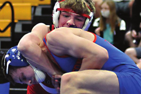 RICHMOND JUNIOR Conner Teat, in the upper position, looks to score points in his 120-pound title match with a familiar foe, Lexington’s Josh Payne, during the Class 1 Sectional 3 Tournament Feb. 27 at Higginsville. SHAWN RONEY | Staff