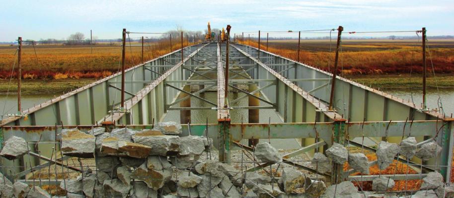STRIPPING the Route J bridge deck for replacement exposes steel ribs and the Crooked River below. J.C. VENTIMIGLIA | Staff