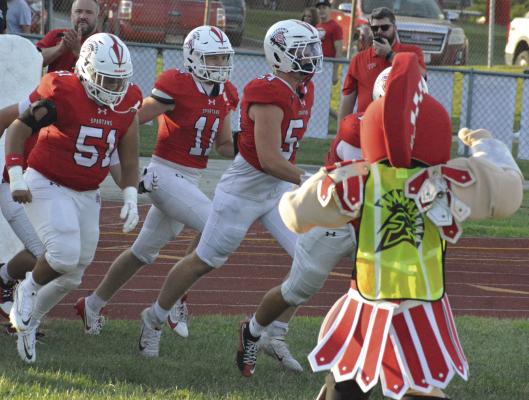 MEMBERS OF THE Richmond varsity 11-man football squad run through the team’s inflatable tunnel and onto the field for the Spartans’ season opener against Oak Grove. Coverage continues on page 12. SHAWN RONEY | Staff