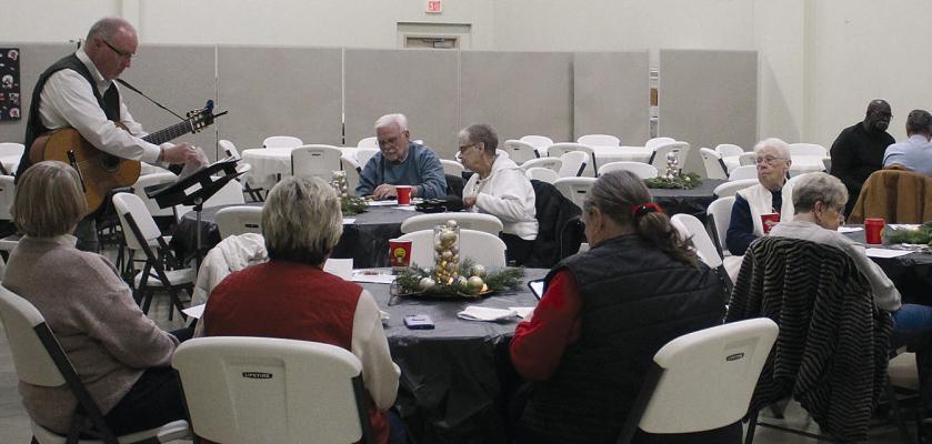UNITED CHRISTIAN PRESBYTERIAN CHURCH Pastor Paul Grant leads the crowd in Christmas carols. SHARON DONAT | Staff