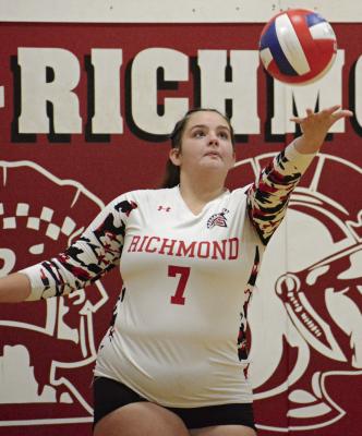 SENIOR PAIGE LOGSDON keeps her eyes on the ball as she prepares to serve during Richmond’s varsity volleyball match with Orrick. The Spartans swept the best-of-five showdown 3-0. SHAWN RONEY | Staff