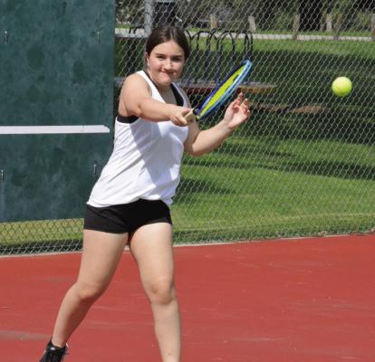 RAEGAN ALDERSON returns a shot from the baseline as the Richmond girls tennis team practices Aug. 10 at Maurice Roberts Park.