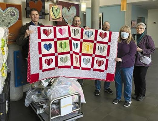 RAY COUNTY FARM BUREAU recently donated quilts handmade by Dona Profitt and Stephanie Wheeler. Shown, from left, are Ed Holbner, Alan Lubbert, Jim Proffitt, Wheeler and Dona Profitt. Each year, the bureau assists in purchasing food and supplies for the Ronald McDonald House, along with a monetary donation. MU | Submitted