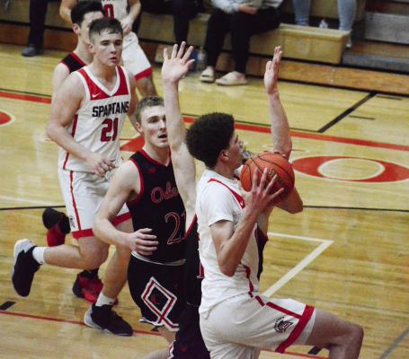 RICHMOND SOPHOMORE Gabe Johnson drives to attempt a second-half layup during the Spartans’ 51-48 loss to Odessa in the Class 4 District 15 title game March 3 at Oak Grove. SHAWN RONEY | Staff