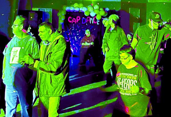 VIVID COLORED LIGHTS and well-known music engage attendees at the Community at Play (CAP) dance. Many dance the night away as CAP continues to gather feedback from our area residents and community members. SOPHIA BALES | Staff