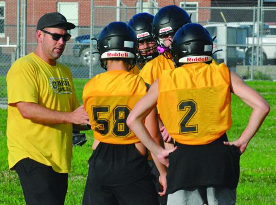 ORRICK VARSITY EIGHT-MAN football coach Matt O’Dell (left) and his Bearcats are helping to make July a joy. SHAWN RONEY | Staff