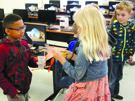 A’VONDRE JACKSON (FROM LEFT), HAZEL DORTON and Preston Davis gather their zip line device to test - putting their Engineer Design Process into action. SOPHIA BALES | Staff