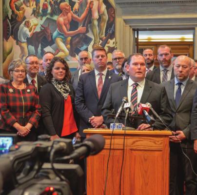 STATE REP. PEGGY McGAUGH, front row, far left, whose district includes all of Ray County, stands among fellow Republicans as House Speaker Rob Vescovo speaks during the Republican press conference in Jefferson City to open this year’s legislative session. BEN PETERS | Missouri House