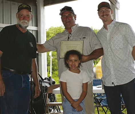 RAY COUNTY FAIR BOARD President Joel Richards (left) presents the 2025 Ray County Farm Family Award to Dale, Ashton and Kehlani Vandiver. Submitted
