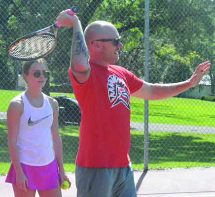 RACQUET IN HAND, new Richmond High School tennis coach Brent Behler discusses technique as Ava Scheible watches Aug. 15 at Maurice Roberts Park. SHAWN RONEY | Staff