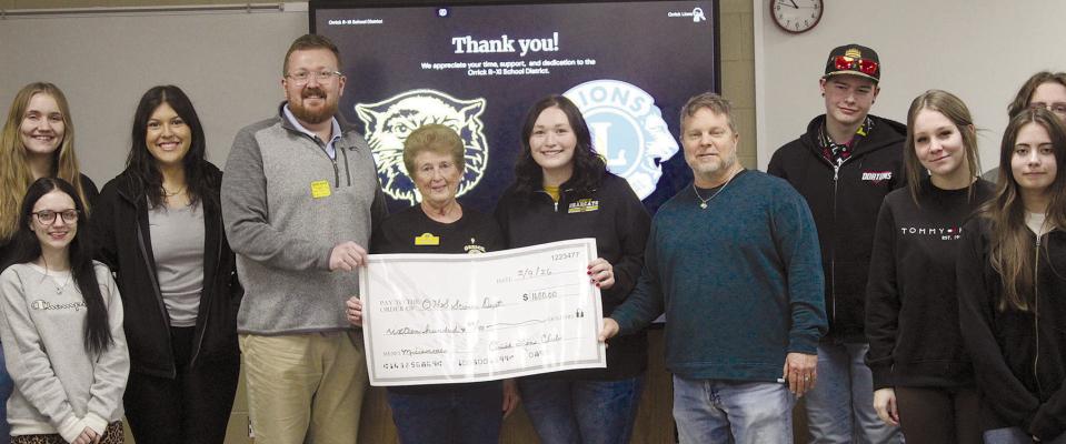 ORRICK LIONS CLUB representatives deliver funding to Orrick High School’s science department for new classroom microscopes. See page 7 for story. MIRANDA JAMISON | Staff