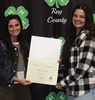 HEATHER AND PAIGE Logsdon show Frank Graham Volunteer certificate awarded posthumonusly for Gwen Gilbow’s service to 4-H.