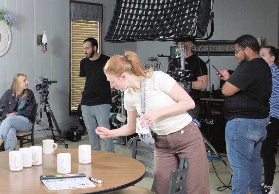 MONICA ALLEY, art director from Five Stone Studios, checks props and last-minute details on the “Farmer’s Table” set before the filming begins June 8 at Daddy’s 10-13 Diner. SOPHIA BALES | Staff