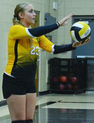 EMERIE QUALLS prepares to serve in Orrick’s season-opening match against Lone Jack. SHAWN RONEY | Staff