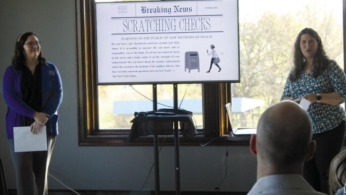 COURTANIE WOODS (left) and Erin Wyse talk about preventing fraud during a recent chamber function. SHARON DONAT | Staff