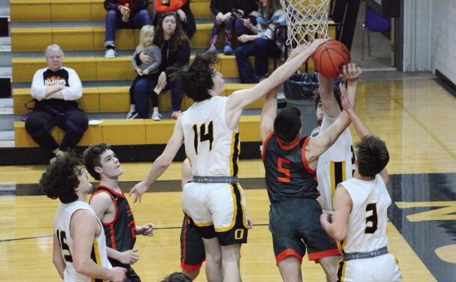 ORRICK JUNIOR Johnathon Harris, No. 14; senior Zander Stevinson, No. 3; and sophomore Tucker Greer surround and contest a second-half shot by Hardin-Central junior Kameron Pugh Feb. 24 in district play at Norborne. SHAWN RONEY | Staff