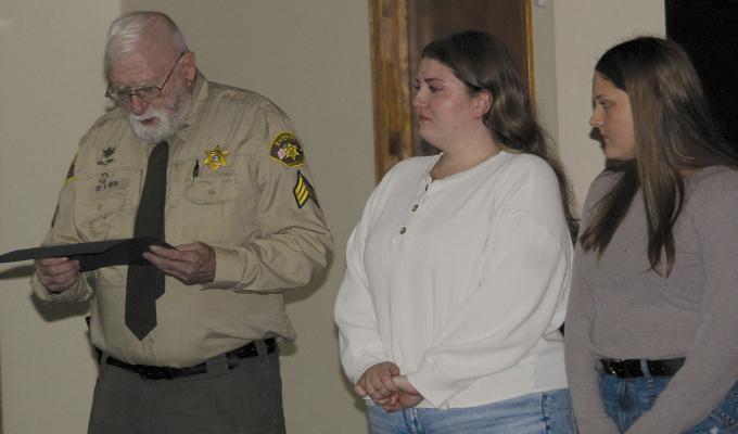 DEPUTY RAY ORTH recognizes sisters Addison (center) and Deborah Jackson after the pair helped save a 90-year-old neighbor by performing CPR and calling 911 during a medical emergency. MIRANDA JAMISON | Staff