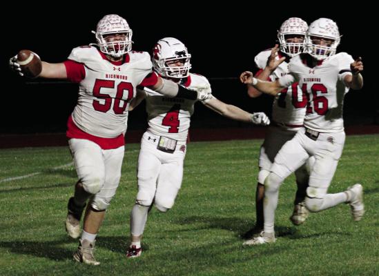 SENIOR JOHN WEBER (left) is jubilant after running in a fumble for a two-point conversion near the end of Richmond’s recent Bell Game 58-22 victory on the road against archrival Lexington. Celebrating with him are Nolan Quick (from left), James Earl and Jacob Johnson. ZANE CREASON | Staff
