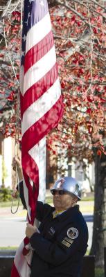 JIM RICHARDSON prepares to raise the courthouse flag during the Veteran’s Day ceremony. SHARON DONAT | Staff