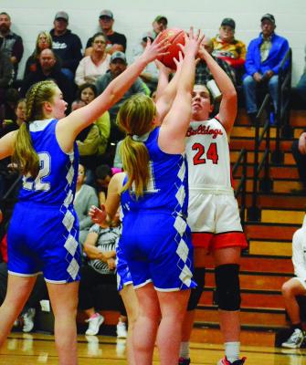 HARDIN-CENTRAL junior Libby Fifer muscles up a second-half jump shot against a double team Dec. 1 against visiting Tri-County. SHAWN RONEY | Staff