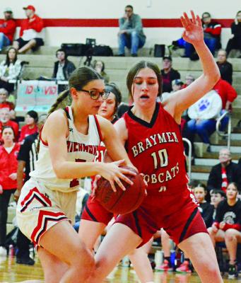 MAYA GRIFFIN keeps both hands on the basketball while being guarded by Morgan Haughton Jan. 26 in tournament action at Richmond Middle School. SHAWN RONEY | Staff
