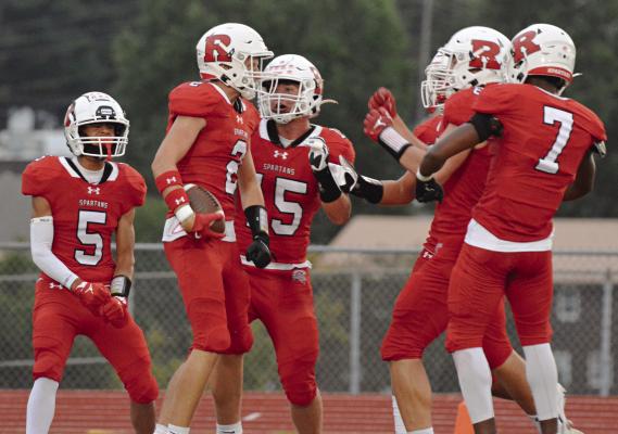 WITH SOME OF his teammates around him, Richmond senior Bryer Farnan (No. 2) celebrates after his first-half pick six against Marshall Sept. 13 at Spartan Stadium. SHAWN RONEY | Staff