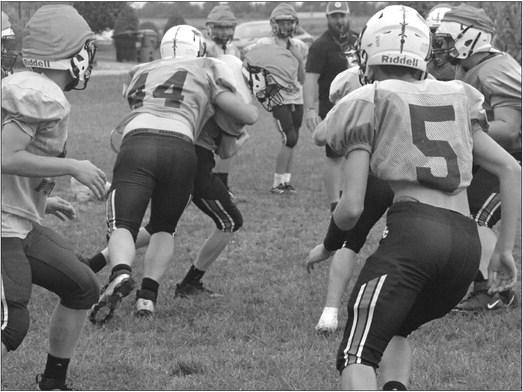 JADEN BARRETT (No. 44) wraps up for a tackle Monday on the practice field at Hardin-Central as the Norborne Hardin-Central varsity 8-man football co-op prepares to face Santa Fe Friday night in Alma. SHAWN RONEY | Staff