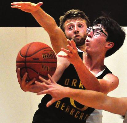 SOPHOMORE JONATHON HARRIS makes a contested drive for the Bearcats Monday during summer-league competition at Lawson. SHAWN RONEY | Staff
