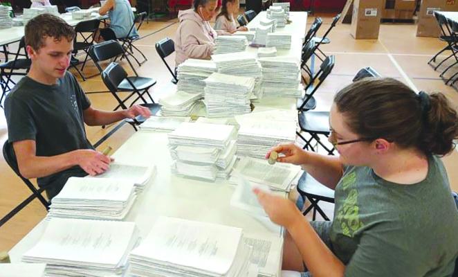 VOLUNTEERS ASSEMBLE Bibles at last year’s Bible Conference. ARCHIVE | Staff