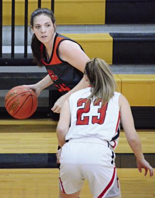 GUARDED BY senior Addyson Sweem, Hardin-Central junior Libby Fifer dribbles to her right during the Bulldogs’ 54-22 loss to Braymer Feb. 23 in Class 1 District 13 play at Norborne. SHAWN RONEY | Staff