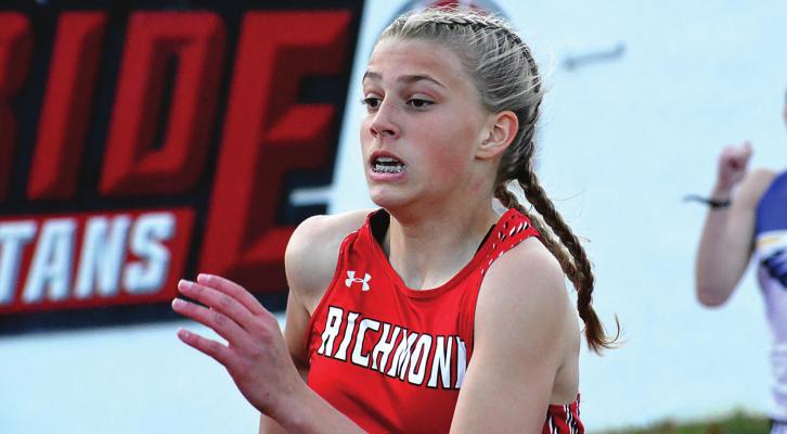 THE BLASTS of wind April 12 do not preclude a certain sports editor/ reporter/photographer from getting a closeup of Kaylee Pugh running the girls 200-meter dash, but they make recording a postrace interview challenging. At least there is no rain during the race or the interview. SHAWN RONEY | Staff