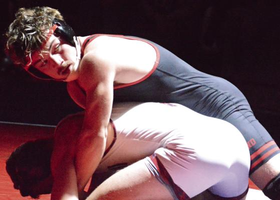 MACK MISENHELTER has the upper hand in his 165-pound match during Richmond’s varsity boys wrestling dual with Lexington. SHAWN RONEY | Staff