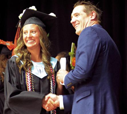 ESTER KINCAID (left) receives her high school diploma from Hardin-Central. SHAWN RONEY | Staff