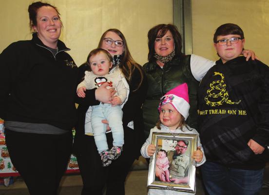 THE LATE Jeff Perkins – a sheriff’s sergeant who led the Shop With a Sheriff program – loses his life to natural causes in October. His wife, Melissa Perkins, steps up to continue the effort. From left are Melissa Perkins, Natalie and Journey Perkins, Mollie Perkins, Wendy Essig and Logan Perkins.