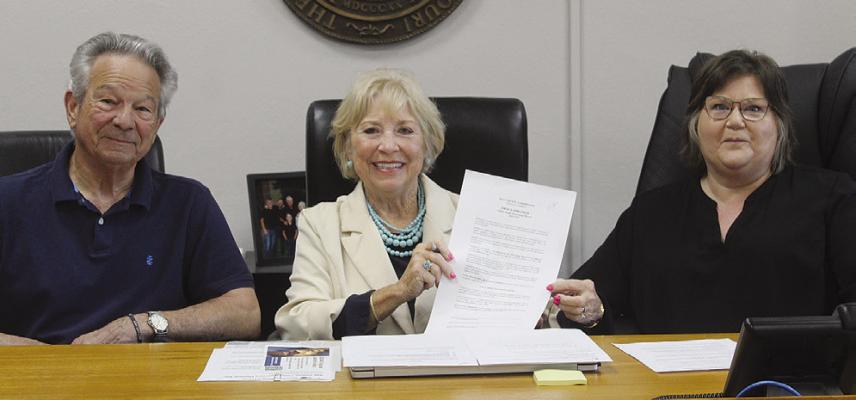 COMMISSIONER MAX HOCKEMEIER (from left), Presiding Commissioner Shelia Tracy and Ray County Collector Julie Chowning present a proclamation recognizing Child Abuse Awareness Month and encouraging residents to wear blue, as well as attend an April 29 courthouse event. MIRANDA JAMISON | Staff