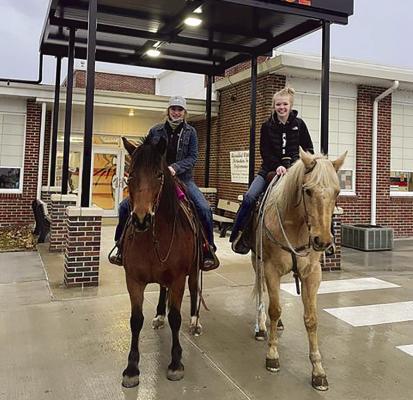 Hardin-Central FFA students ride horses to school on Drive A Tractor Day