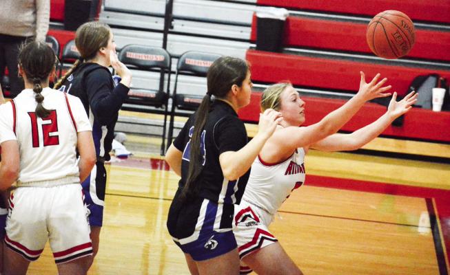 HER ARMS outstretched, junior Laney Moyer tries to keep the ball in play for Richmond Jan. 27 against Lone Jack in the Richmond Winter Classic. SHAWN RONEY | Staff