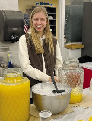 HIGH SCHOOL FFA student Emerson Rennison is excited to serve orange juice during the annual FFA breakfast, hosted by the Richmond High club. SOPHIA BALES | Staff
