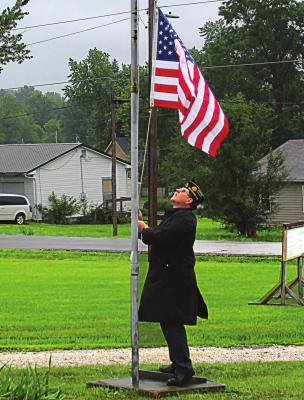THE MEMORIAL DAY ceremony – a joint observance between Richmond’s American Legion and Veterans of Foreign Wars posts at Woodland Cemetery – starts in a soft rain with American Legion Commander Mark Foley raising the flag. Find more event photos on Page 10. J.C. VENTIMIGLIA | Staff