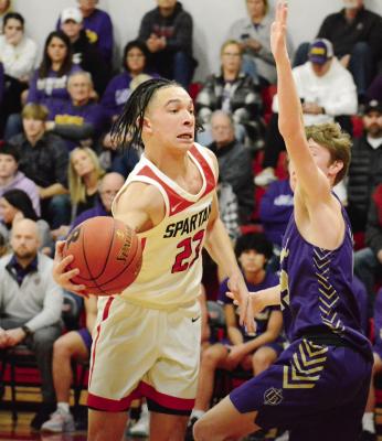 SENIOR DONIVIN WILLIAMS attempts a one-handed pass during the Spartans’ 79-62 win over Bishop LeBlond of St. Joseph in the Richmond Winter Classic title game Jan. 28 at Richmond High School. SHAWN RONEY | Staff