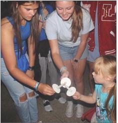LAWSON HIGH School students make sure all candles are lit in the memory of their fellow classmate. MIRANDA JAMISON | Staff