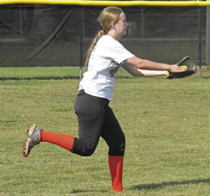 ZOEY POLK drills over catching fly balls during a recent practice at Norborne as she and her Norborne Hardin-Central teammates prep for the varsity season under Tommy Dunkin, their new skipper. SHAWN RONEY | Staff