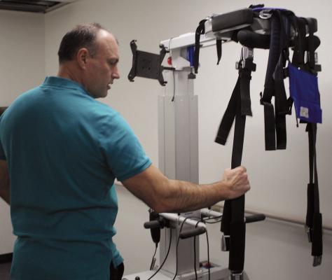RANDY SINGLETON adjusts the Light Gate system used for lift support and gait training at Shirkey Premier Therapy.