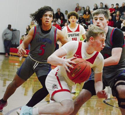 SOPHOMORE NOLAN QUICK dribbles to his right during the second half of Richmond’s Feb. 9 mat/ courtwarming meeting with visiting Lexington. SHAWN RONEY | Staff