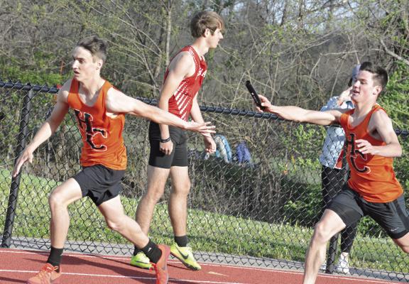 STRETCHING BACK with his left hand, Brody Fifer reaches to grab the baton from Hardin-Central teammate Kameron Pugh during the boys 800-meter relay race April 11 at the Bill Hamann Invitational at Lexington. SHAWN RONEY | Staff