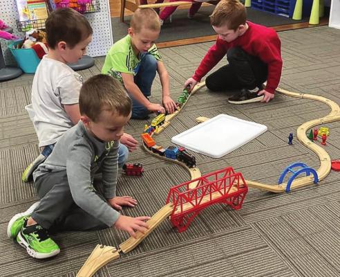 THESE BOYS design a pathway on which trains can travel. From front to back are Zander Marrant, Camden Breland-Armstrong, Drew Schutz and Stetson Hamilton.
